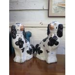 A pair of Victorian black and white Staffordshire dogs, 32cm high