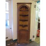 A Georgian style pine display cabinet, with three shaped open shelves in an alcove over a cupboard