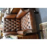 A LATE 20TH CENTURY BROWN LEATHER BUTTON BACK UPHOLSTERED WING BACK ARMCHAIR, 76cm wide