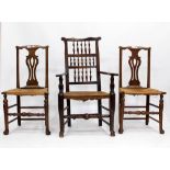 A PAIR OF 19TH CENTURY OAK SPLAT BACK KITCHEN CHAIRS with rush seats and a similar armchair (3)