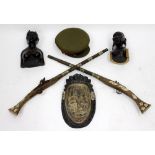 TWO OLD REPRODUCTION FLINT LOCK GUNS, two carved ebony figures, a carved wooden mask and a hat