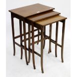 A MAHOGANY CROSS BANDED NEST OF THREE TABLES, the largest measuring 69cm high