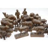 A GROUP OF ORIENTAL CARVED WOODEN FIGURES AND ANIMALS, tigers, elephants, rhinos etc