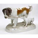 A NYMPHENBURG PORCELAIN FIGURE GROUP of a dog and puppy pulling on its tether, with impressed