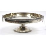 A BIRMINGHAM SILVER CIRCULAR SHALLOW DISH with hinged carrying handles, standing on socle base,