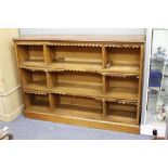 A VICTORIAN MAHOGANY OPEN FRONT BOOKCASE with nine fixed compartments and raised on a plinth base,