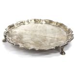 A BIRMINGHAM SILVER SALVER on three pad feet with wavy edge border, dated 1941 with inscription on