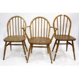 A SET OF FIVE LIGHT ELM SPINDLE BACK ERCOL STYLE KITCHEN CHAIRS to include one carver