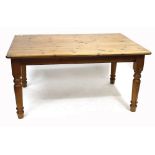 A LATE 20TH CENTURY PINE RECTANGULAR TOPPED KITCHEN TABLE with turned legs, the top 105cm x 150cm