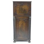 AN ANTIQUE MAHOGANY PEDESTAL CUPBOARD with lifting lid and cupboard beneath, flanked by cable