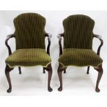 A PAIR OF GEORGIAN STYLE OPEN ARMCHAIRS with shepherds crook arms and striped green upholstery, 62cm