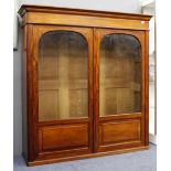 A LATE VICTORIAN SATIN WOOD WALNUT TWO DOOR DISPLAY CABINET with arched glazed panels over fielded