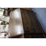 A LATE GEORGIAN OAK WRITING DESK fitted with three drawers below a fall front, standing on bracket