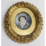 AN ANTIQUE OVAL MINIATURE PORTRAIT of a young girl with a white shawl in a decorative gilt frame 9cm