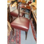 A SET OF EIGHT REGENCY BAR BACK DINING CHAIRS with sabre legs and burgundy leather upholstered seats