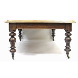 A VICTORIAN MAHOGANY PULL OUT EXTENDING DINING TABLE with turned legs and brass casters (three