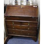 A GEORGIAN STYLE OAK BUREAU fitted with two over two drawers, standing on shaped bracket feet,