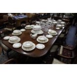 A LARGE GEORGIAN STYLE HARDWOOD TRIPLE PEDESTAL DINING TABLE complete with two extra leaves, each