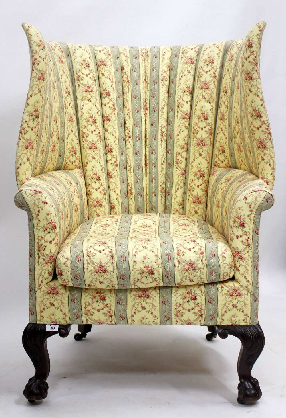 A HOWARD & SONS HIGH BACKED CHAIR standing on ball and claw feet, marked on rear leg 78340