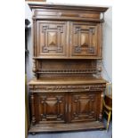 A CONTINENTAL OAK CUPBOARD with twin moulded doors above two single drawers above twin doors and