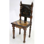 A VICTORIAN CARVED OAK HALL CHAIR with parquetry seat and turned legs