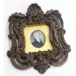 AN ANTIQUE MINIATURE PORTRAIT of a gentleman painted on ivory and mounted in a Rococo style frame