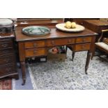 A MAHOGANY GILLOWS STYLE FIVE DRAWER WRITING TABLE with reeded tapering legs, 122cm wide x 82.5cm