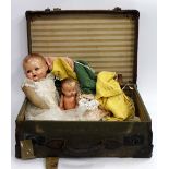 AN OLD CASE with two early 20th Century German made dolls and knitted dolls clothes