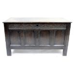 AN ANTIQUE OAK COFFER with quadruple panelled front 106cm wide x 59cm high