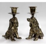 A PAIR OF SILVER PLATED CANDELABRA in the form of dogs, each 14cm in height