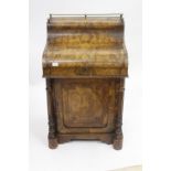 A VICTORIAN BURR WALNUT VENEERED DAVENPORT with marquetry inlaid decoration, turned pilaster