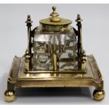 A 20TH CENTURY BRASS FRETWORK DESK STAND with glass inkwell