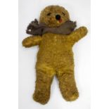 AN OLD STRAW FILLED TEDDY BEAR, 74cm in length