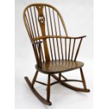 AN ERCOL SPINDLE BACK ROCKING CHAIR