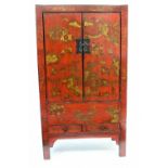A 20TH CENTURY CHINESE RED LACQUERED CABINET with twin doors above two short drawers 85cm wide x