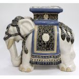AN ORIENTAL POTTERY PLANT STAND or seat in the form of an elephant 42cm high