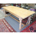 A RECTANGULAR TOPPED PINE REFECTORY TABLE with turned supports united by a stretcher, the top 81cm x