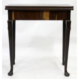 AN EARLY GEORGE III MAHOGANY FOLDOVER CARD TABLE fitted with frieze drawer, standing on pad feet