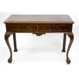 A GEORGIAN STYLE MAHOGANY FOLD OVER SERVING TABLE fitted with two frieze drawers standing on ball