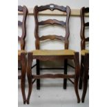 A SET OF SIX FRENCH LADDER BACK KITCHEN CHAIRS with rush seats (6)