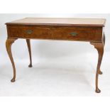 A LATE 19TH / EARLY 20TH CENTURY WALNUT SIDE TABLE fitted with two line inlaid frieze drawers,