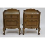 A PAIR OF FRENCH OAK BEDSIDE CABINETS each with a drawer and panel cupboard door to the front and