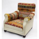 A KELIM STYLE COVERED ARMCHAIR standing on bun feet 85cm high