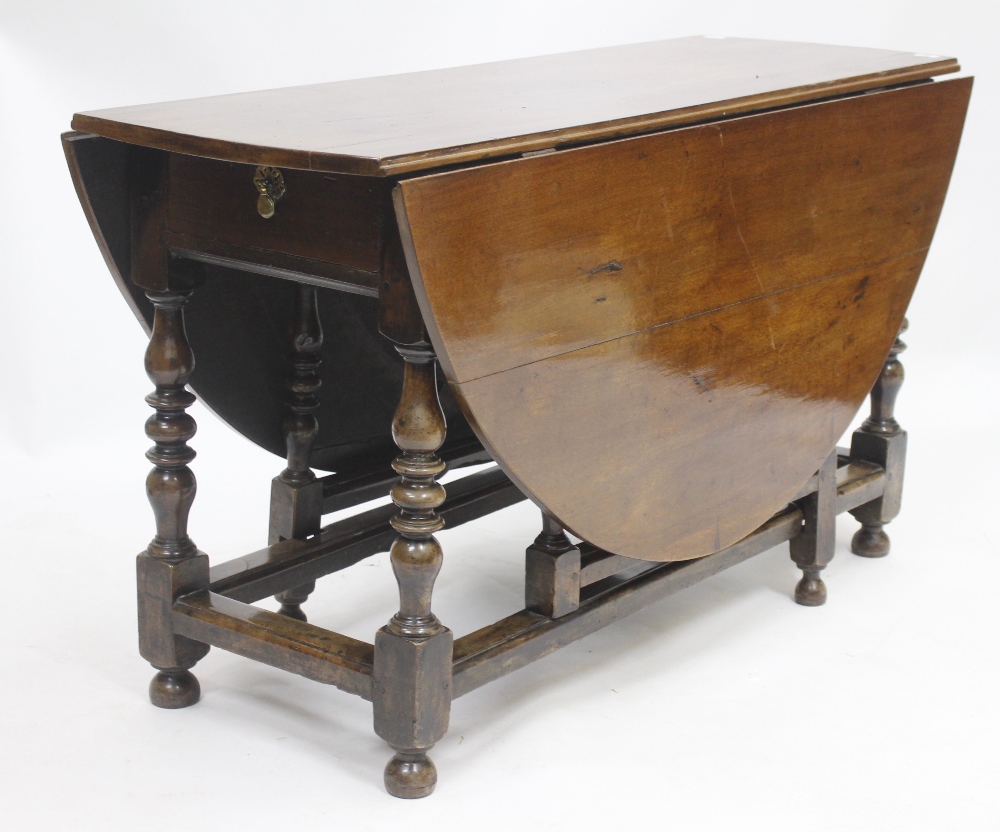 AN 18TH CENTURY AND LATER GATELEG TABLE with oval top and turned supports, 129.5cm wide x 72cm high