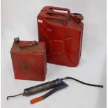 AN OLD PETROLEUM SPIRIT CANISTER 24cm wide, a further petrol canister and a grease gun (3)