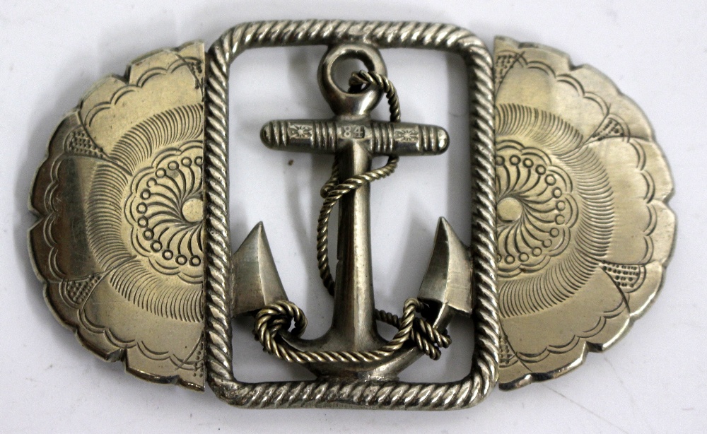 A JAPANESE WHITE METAL BELT BUCKLE with a central anchor design relating to a Japanese dreadnaught