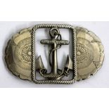 A JAPANESE WHITE METAL BELT BUCKLE with a central anchor design relating to a Japanese dreadnaught