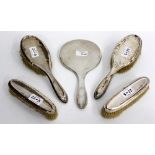 A SET OF FIVE SILVER BACKED DRESSING TABLE REQUISITES including four brushes and a mirror (AF) (5)
