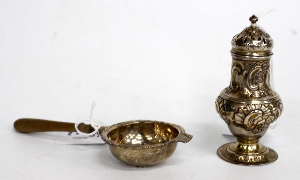 A GEORGIAN SILVER SUGAR SIFTER by Thomas Shepherd and a silver tea strainer with turned handle (2)