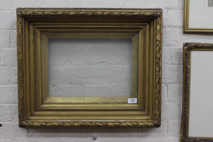 A PAIR OF GILDED RECTANGULAR PICTURE FRAMES with beaded and acanthus leaf mouldings, each aperture